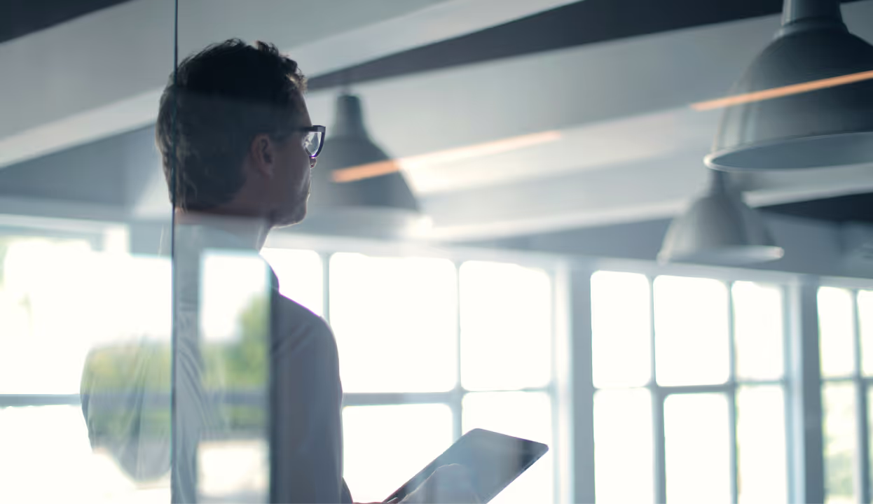 Man holding a tablet in a modern office
