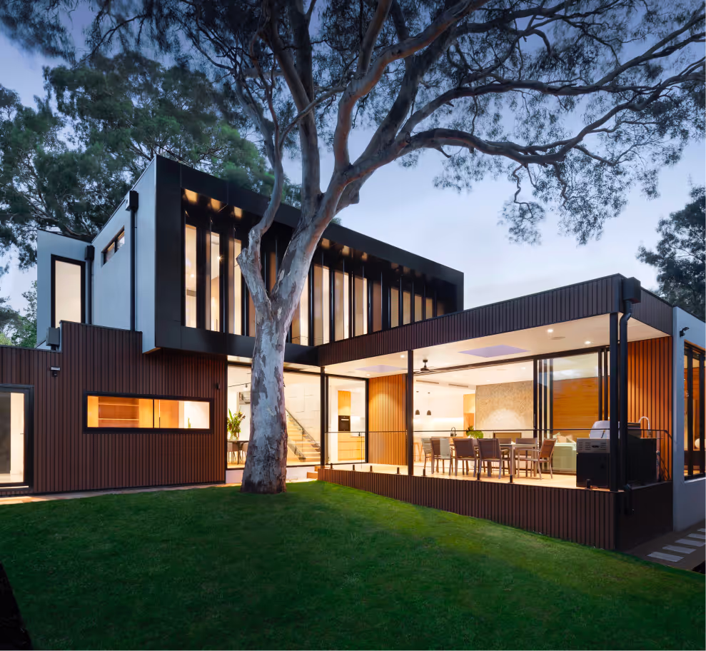 Modern home lit up at dusk