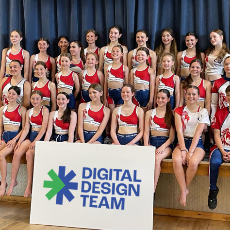 Allstars Academy dancers with a Digital Design Team sign