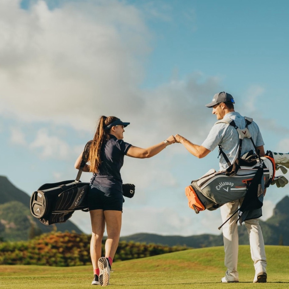 Golfers on the Moka Rangers Sports Club driving range with the Moka mountains behind